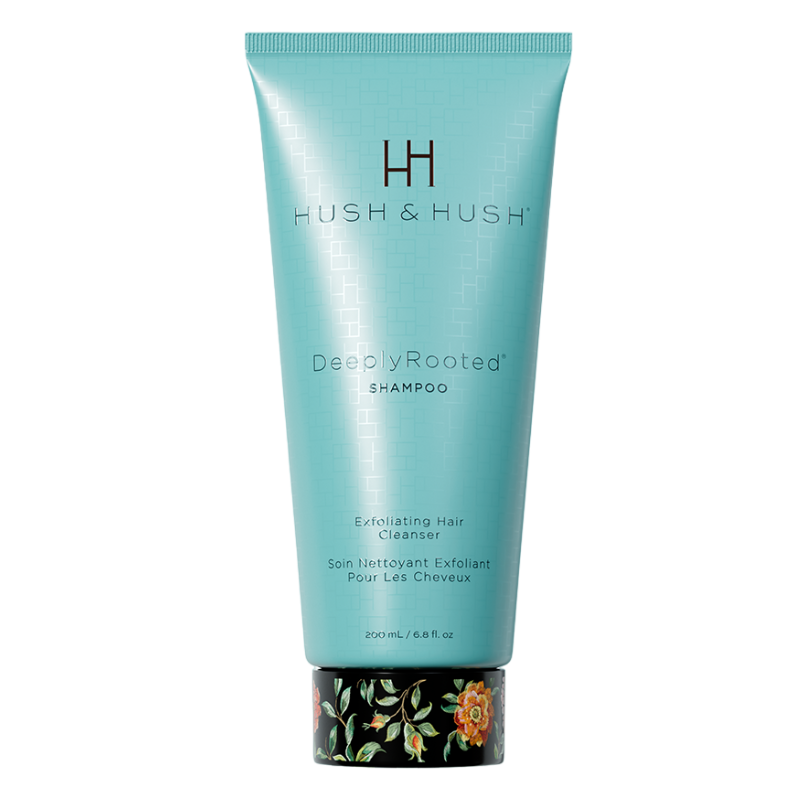 HUSH-HUSH-DEEPLYROOTED-SHAMPOO HUSH & HUSH DeeplyRooted Shampoo, 200 ml, exfolierendes Haarreinigungsmittel in türkisfarbener Tube mit floralem Design am Boden.