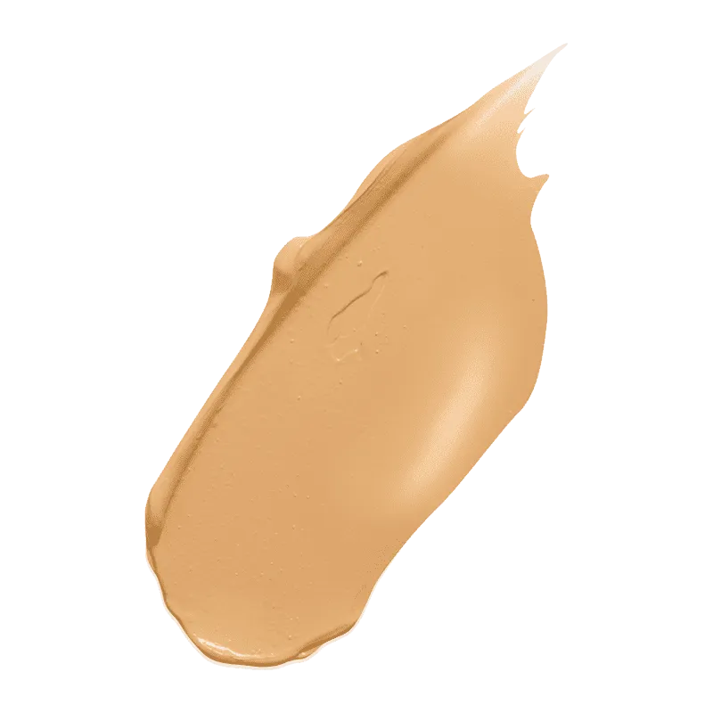 Beige Concealer-Swatch auf grünem Hintergrund.
