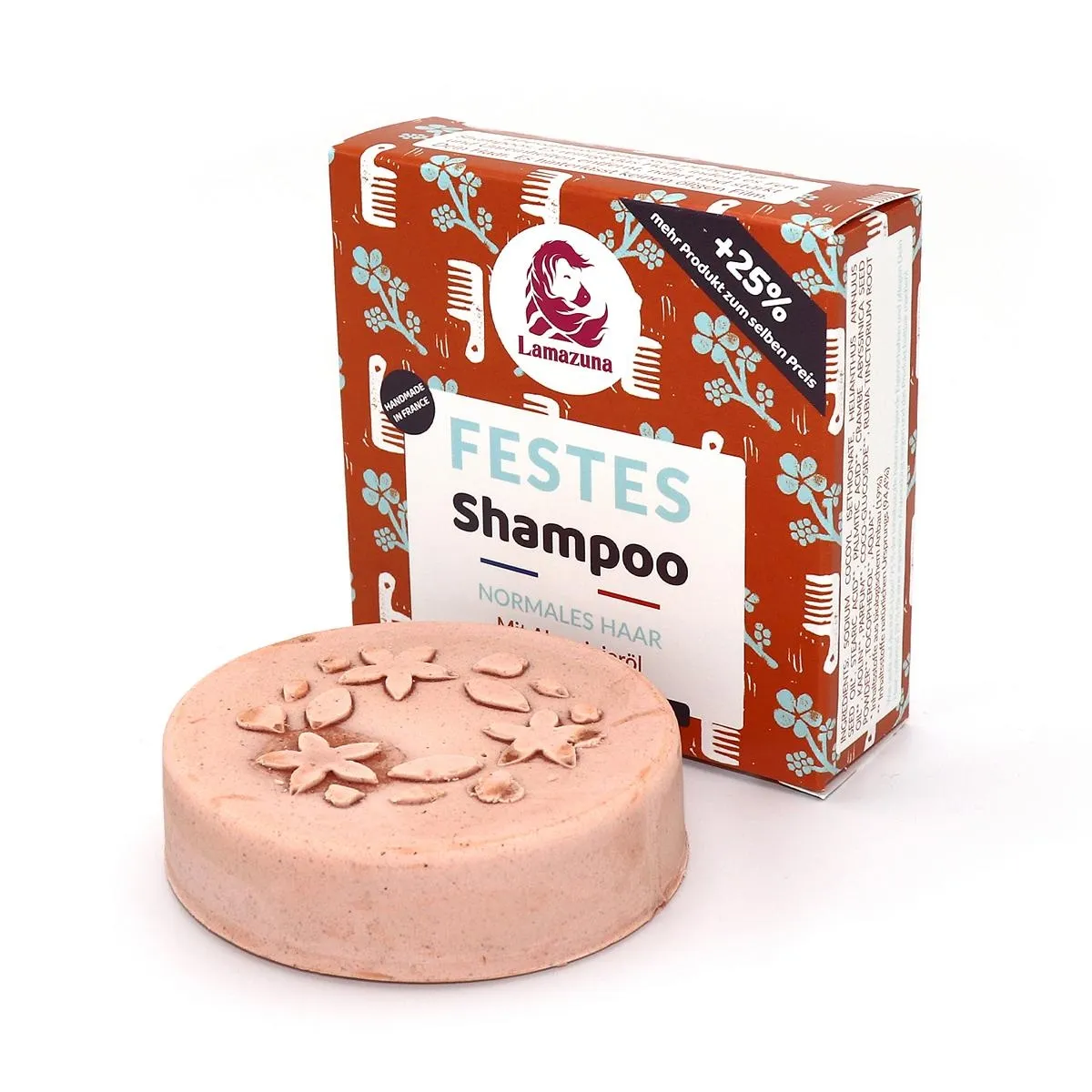 Festes Shampoo für normales Haar von Lamazuna, verpackt in einer braunen Schachtel mit Blumenmuster, daneben eine runde Seife.