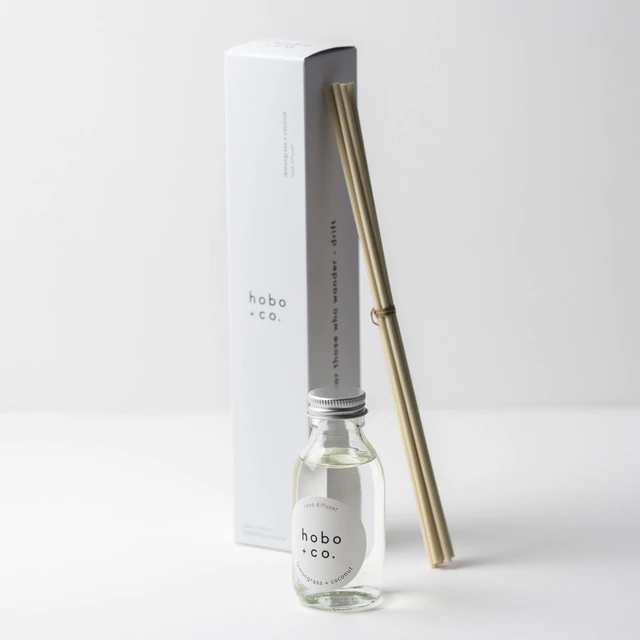 Hobo+Co Raumduft-Set mit Glasflasche und Bambusstäbchen auf weißem Hintergrund.