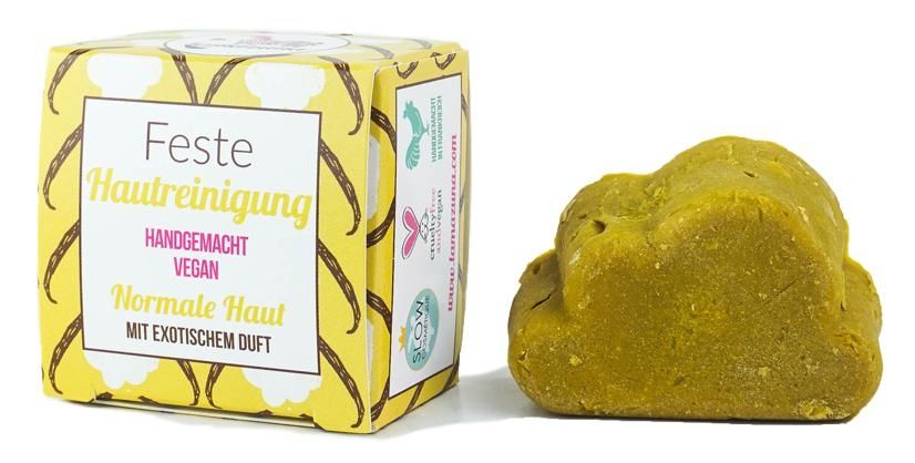 Handgemachte vegane feste Hautreinigung für normale Haut mit exotischem Duft, Verpackung und Seifenstück nebeneinander.