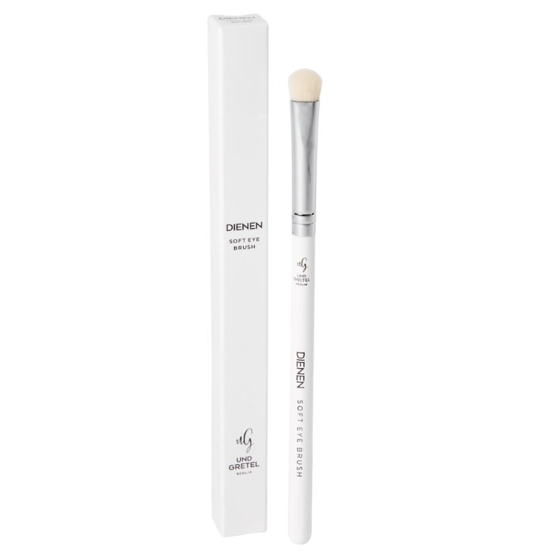 UND GRETEL DIENEN Soft Eye Brush neben Verpackung, weißer Griff, silberne Zwinge, weiche Borsten.