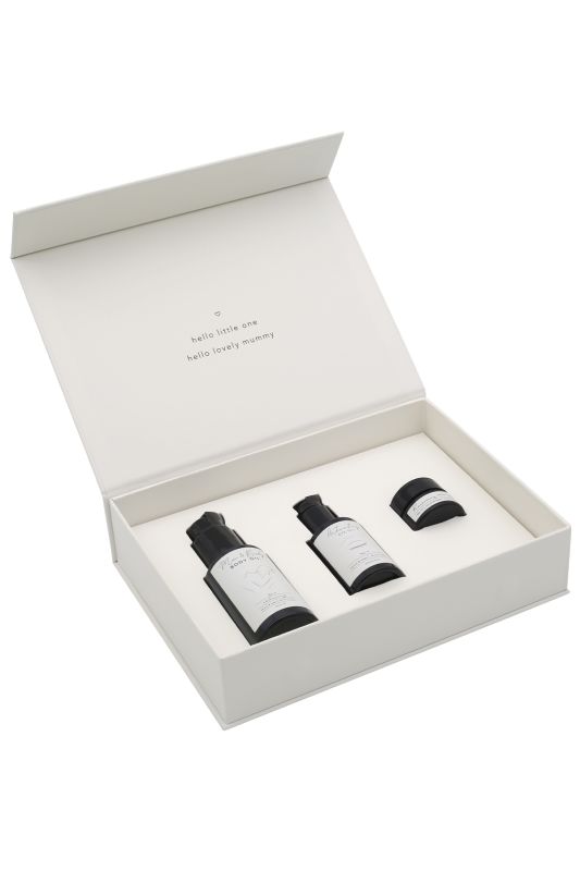 Offene weiße Geschenkbox mit drei Kosmetikprodukten für Mutter und Baby.